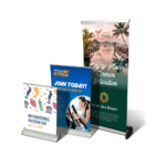 Three distinct banner displays showcasing vibrant designs and promotional messages, representing trade show and event marketing solutions offered by Design One Printing.