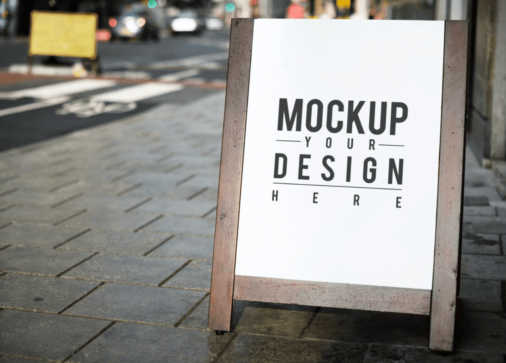 Mockup sign displaying customizable design options for promotional products and signage in urban setting.