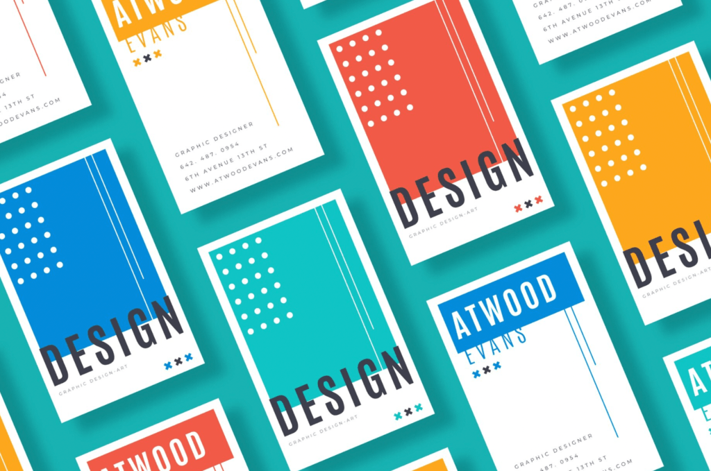 Colorful business cards featuring the name "Atwood Evans," graphic design services, and bold "DESIGN" text, arranged in a visually appealing layout.