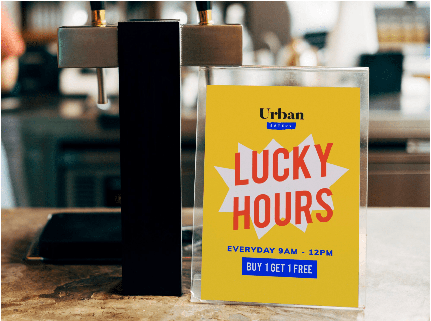TABLE TENTS Table tent displaying "Lucky Hours" promotion for Urban Eatery, featuring bright yellow background, bold red text, and details about the offer: "Everyday 9AM - 12PM, Buy 1 Get 1 Free."